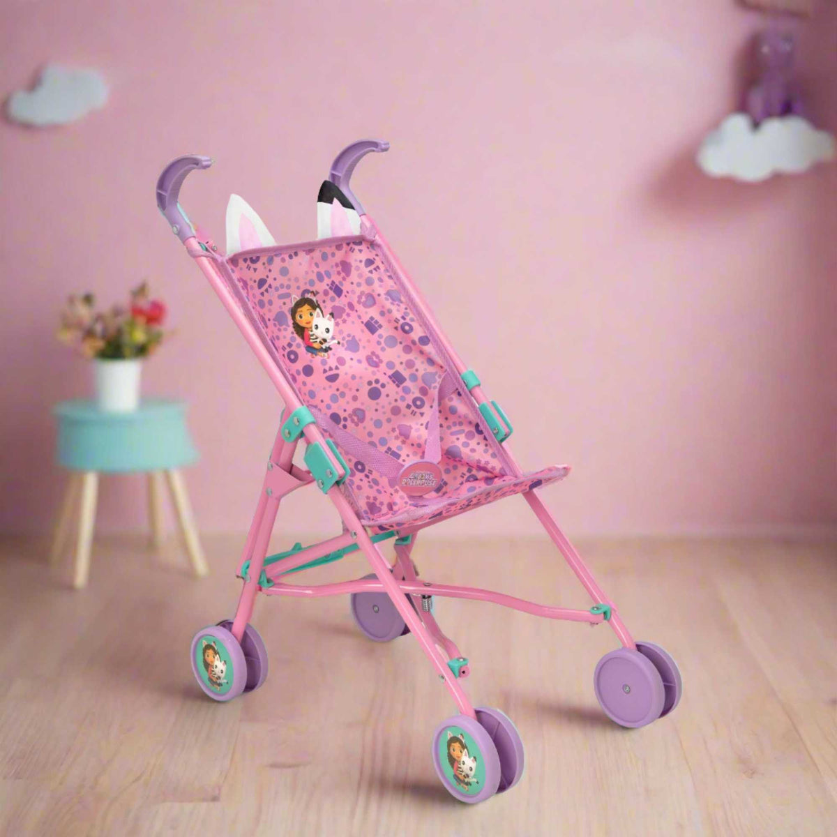 Colourful toy stroller featuring popular characters from Gabby&#39;s Dollhouse, designed for children to enjoy pretend play. Ideal for carrying dolls and other small toys, with vibrant designs and sturdy wheels for easy manoeuvrability.