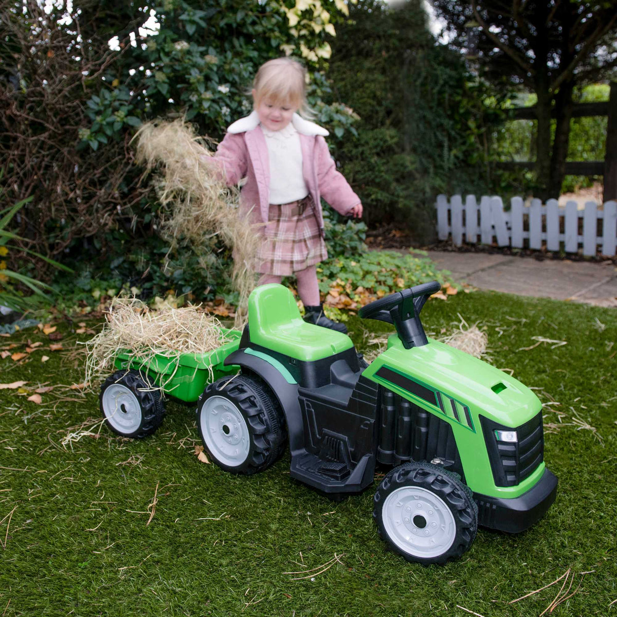 Electric green EVO Green Tractor &amp; Trailer Ride-On for 2-year-olds, featuring a realistic tractor design, detachable trailer, ergonomic seat, and easy-to-use controls for safe and fun farmyard adventures.