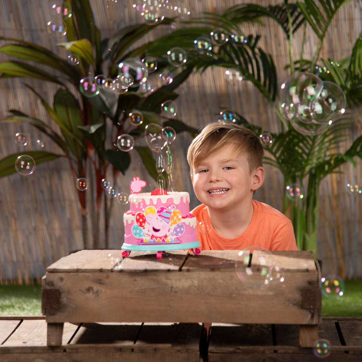 Peppa Pig Birthday Cake Bubble Machine featuring fun cake design, blowing bubbles for kids&#39; parties, playdates, and outdoor activities, perfect for Peppa Pig fans.