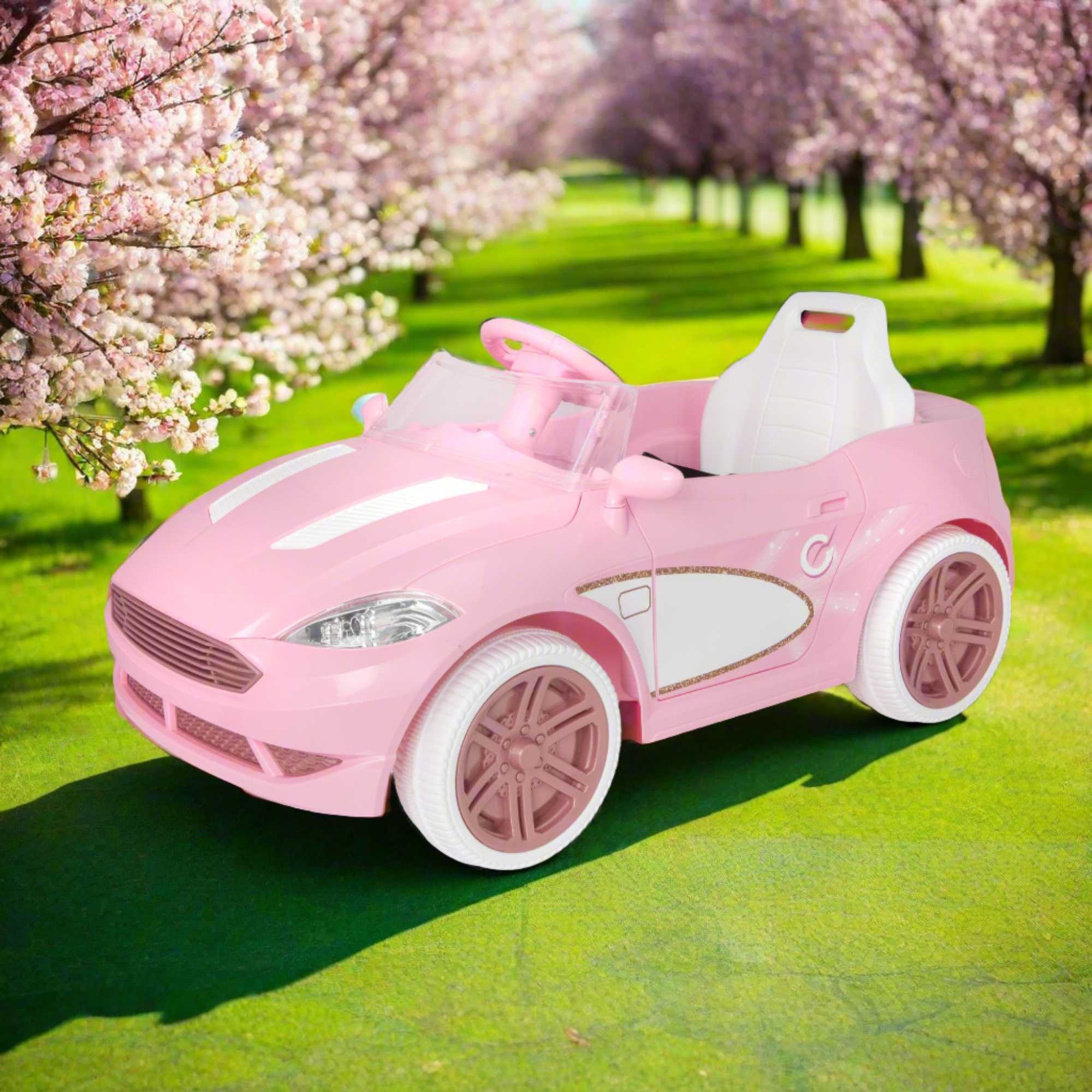 Pink EVO Dream Coupe Car Ride-On Toy for children aged 3+, featuring pedal-driven forward and reverse motion, working headlights, and authentic engine and horn sounds