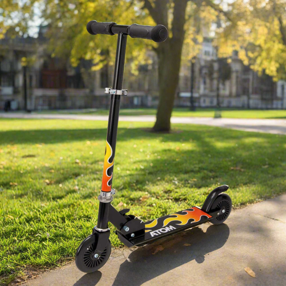 ATOM Inline 2-wheeled children&#39;s scooter in a sleek black flames theme, featuring a robust design, fiery graphics, and an exciting style perfect for young adventurers