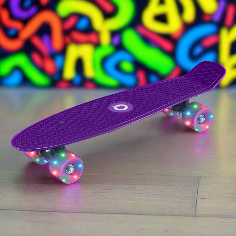 Children’s EVO 22-inch Penny Board in pink with light-up wheels, showcasing a compact design and vibrant retro style, perfect for young riders. The board features a textured grip surface and smooth, illuminated wheels that light up during movement. 