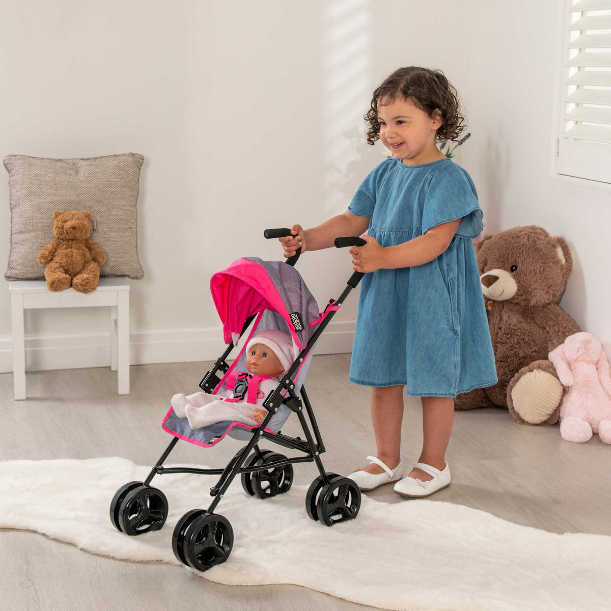 Mamas &amp; Papas Junior Cruise Stroller, designed for children&#39;s imaginative play, featuring a sleek and modern design with sturdy frame and smooth-rolling wheels, perfect for pretend outings with dolls.