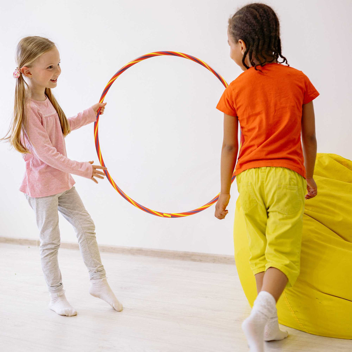 Rainbow Hula Hoops, a pack of four lightweight, durable hoops in bright rainbow colours. Ideal for parties, picnics, and outdoor fun, promoting movement, coordination, and social play for all ages.