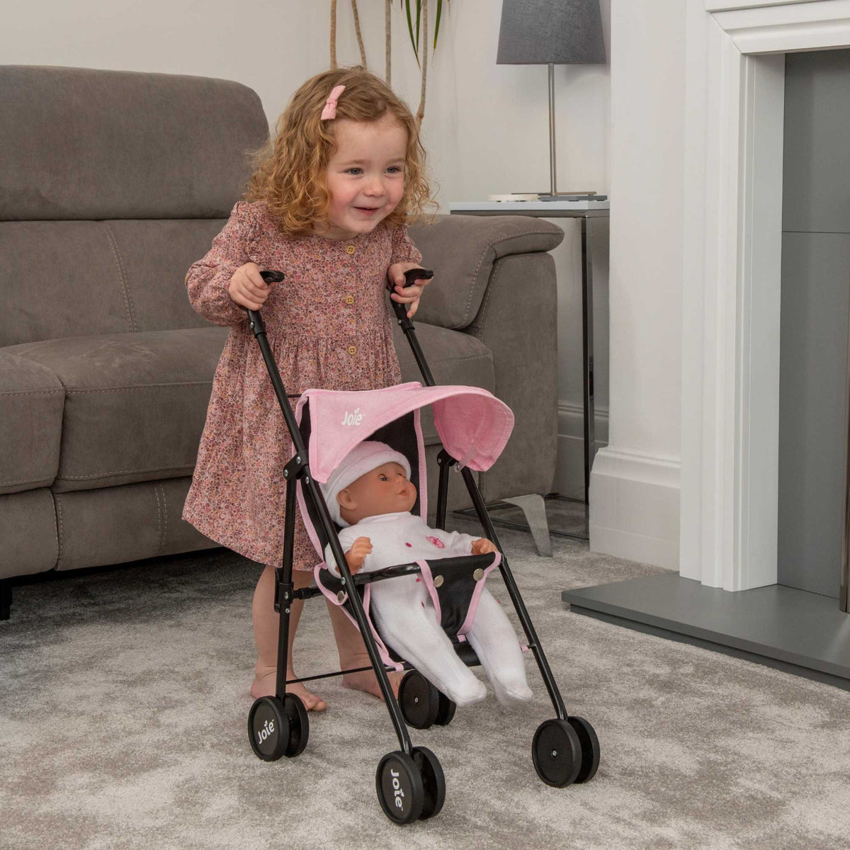 Stylish and compact toy pushchair designed for dolls, featuring a lightweight frame, easy-to-manoeuvre wheels, and a comfortable handle. Perfect for children to take their favourite dolls on the go, with a sleek and modern design.