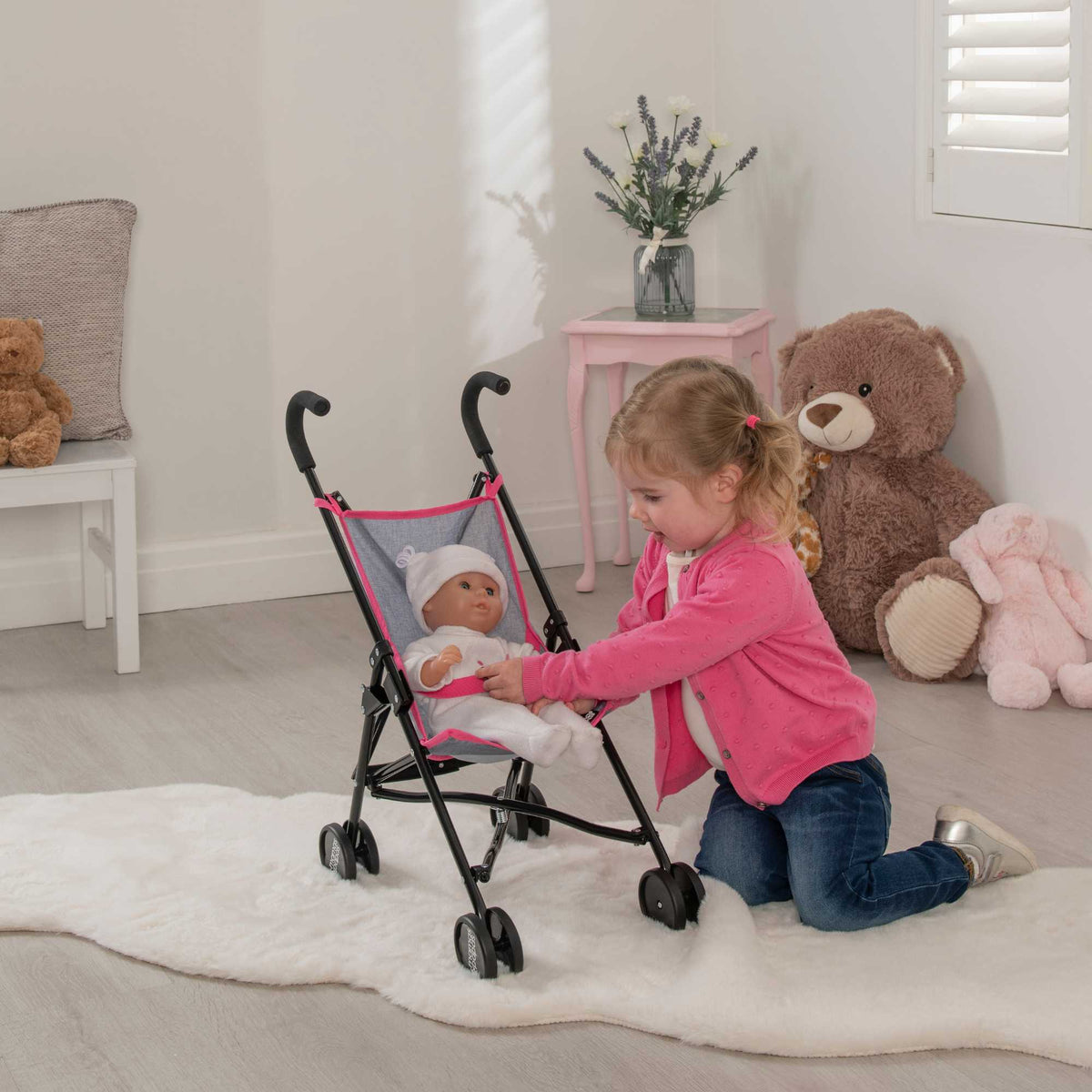 Mamas &amp; Papas Junior Doll Stroller in pink and grey, featuring a foldable and lightweight design for easy storage and portability, ideal for children&#39;s imaginative play with dolls.