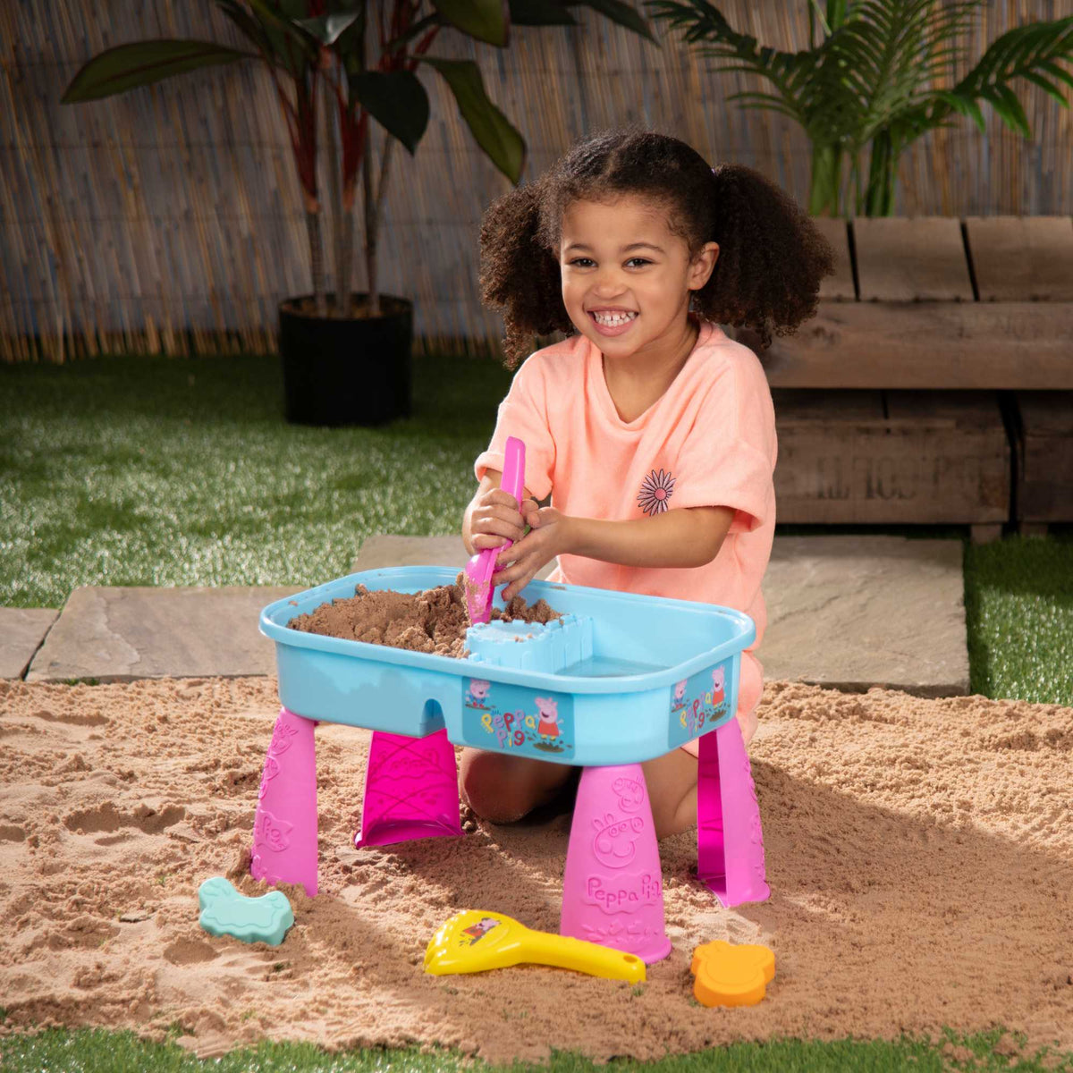 Peppa Pig Sand &amp; Water Play Table with fun accessories for kids, featuring separate sand and water compartments, perfect for outdoor sensory play and Peppa Pig fans.