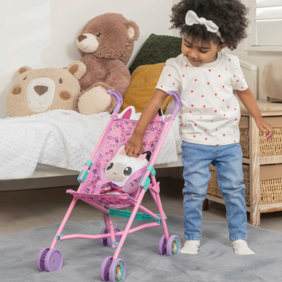 Colourful toy stroller featuring popular characters from Gabby&#39;s Dollhouse, designed for children to enjoy pretend play. Ideal for carrying dolls and other small toys, with vibrant designs and sturdy wheels for easy manoeuvrability.