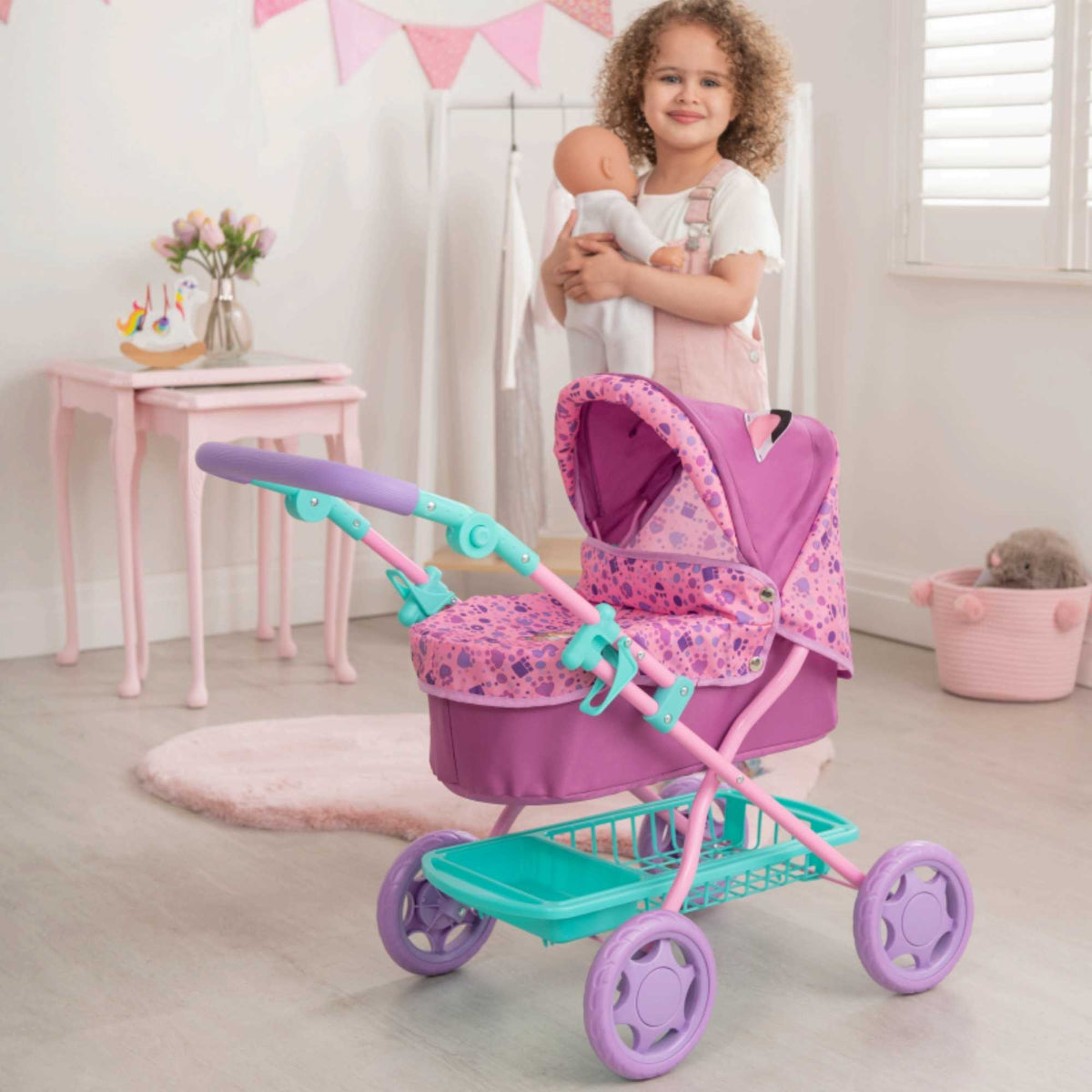 Adorable and colourful toy pram inspired by Gabby&#39;s Dollhouse, perfect for children to transport their favourite dolls and stuffed animals. Features include a sturdy frame, easy-to-push wheels, and playful designs with popular characters from the show. 