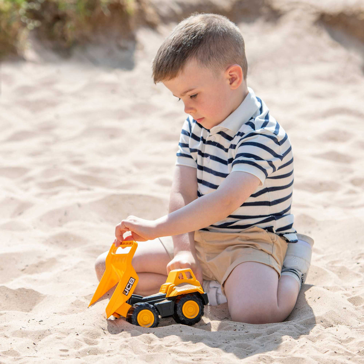 7-inch JCB Dump Truck Toy featuring realistic design, rugged wheels, and a functional dump bed, perfect for indoor and outdoor play for children.