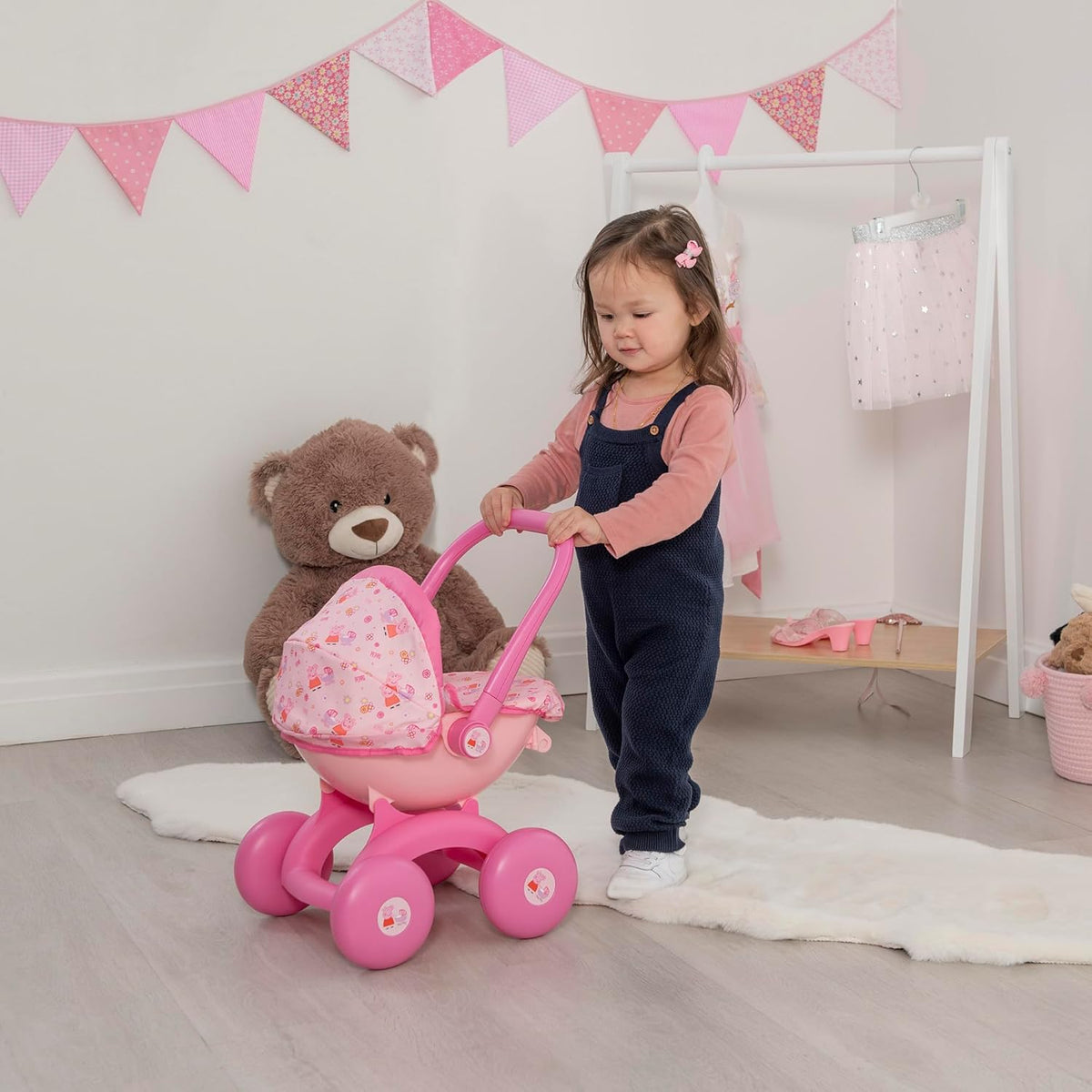 Peppa Pig 4-IN-1 My First Pram: A pink and white toy pram featuring Peppa Pig graphics, designed for toddlers with four versatile play modes, perfect for imaginative play and doll carrying.