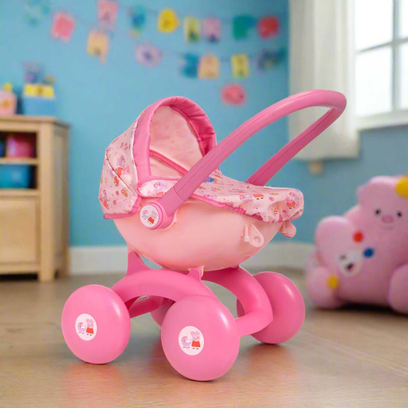 Peppa Pig 4-IN-1 My First Pram: A pink and white toy pram featuring Peppa Pig graphics, designed for toddlers with four versatile play modes, perfect for imaginative play and doll carrying.