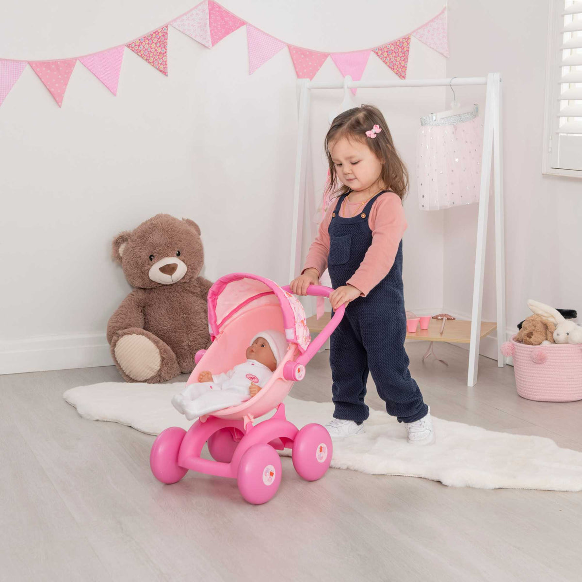 Peppa Pig 4-IN-1 My First Pram: A pink and white toy pram featuring Peppa Pig graphics, designed for toddlers with four versatile play modes, perfect for imaginative play and doll carrying.