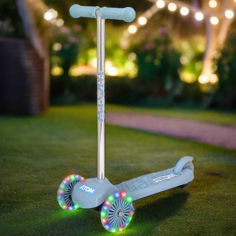 ATOM Move N Groove Light Up 3-wheeled scooter with flashing LED wheels, colourful design, and tilt to steer system, offering a fun and stable ride for children.