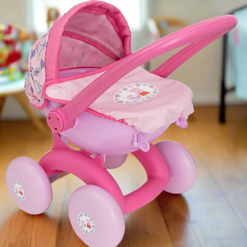 Peppa Pig 4-in-1 Pram, a versatile dolls’ stroller for dolls up to 35cm. Features a detachable carrycot, front-facing pushchair, and baby seat with an adjustable hood, removable apron, and Peppa Pig-themed pink design.