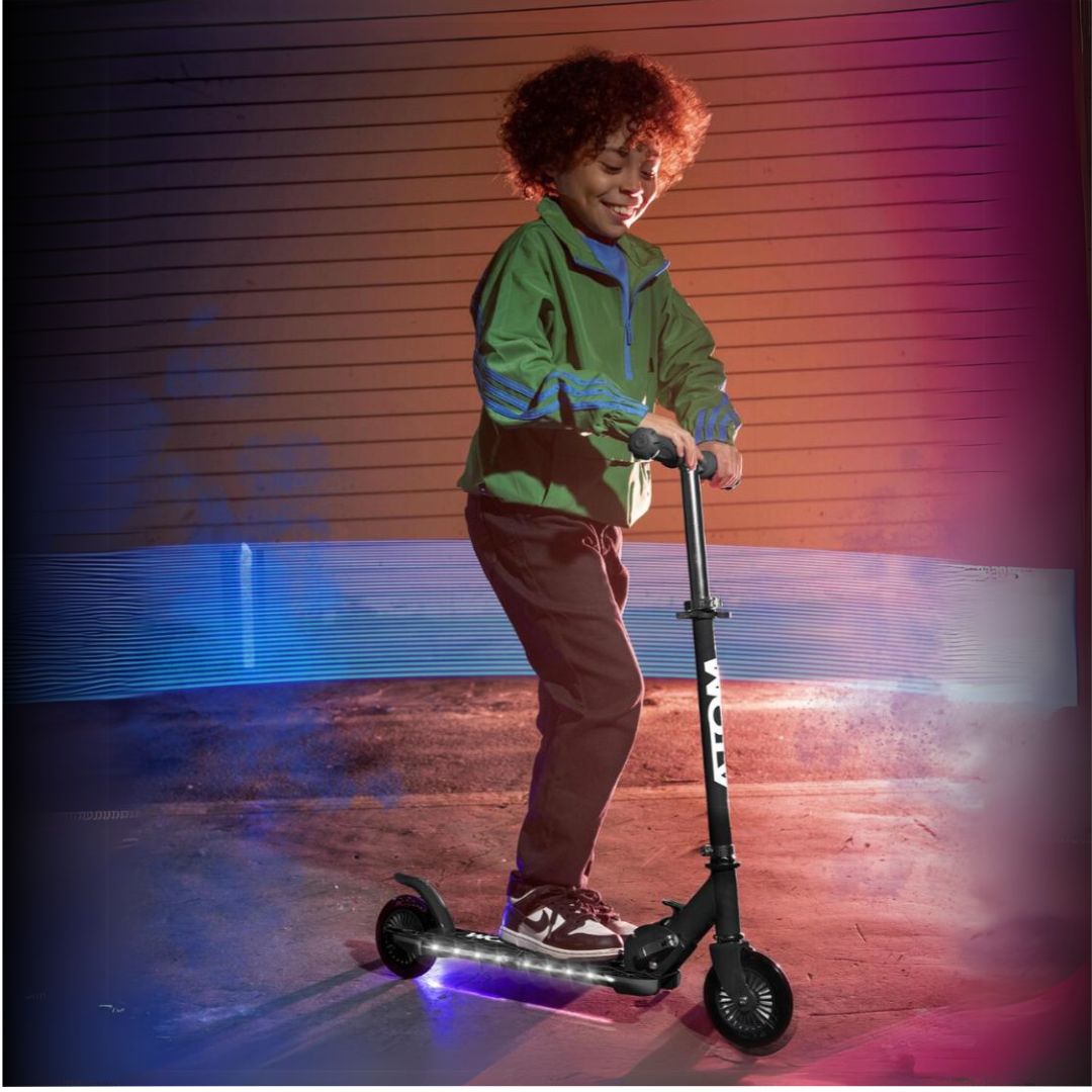 ATOM Night Flash 2-wheeled scooter for kids aged 5 and up, featuring LED light-up wheels, a sturdy frame, and adjustable handlebars, designed for safe and exciting rides.