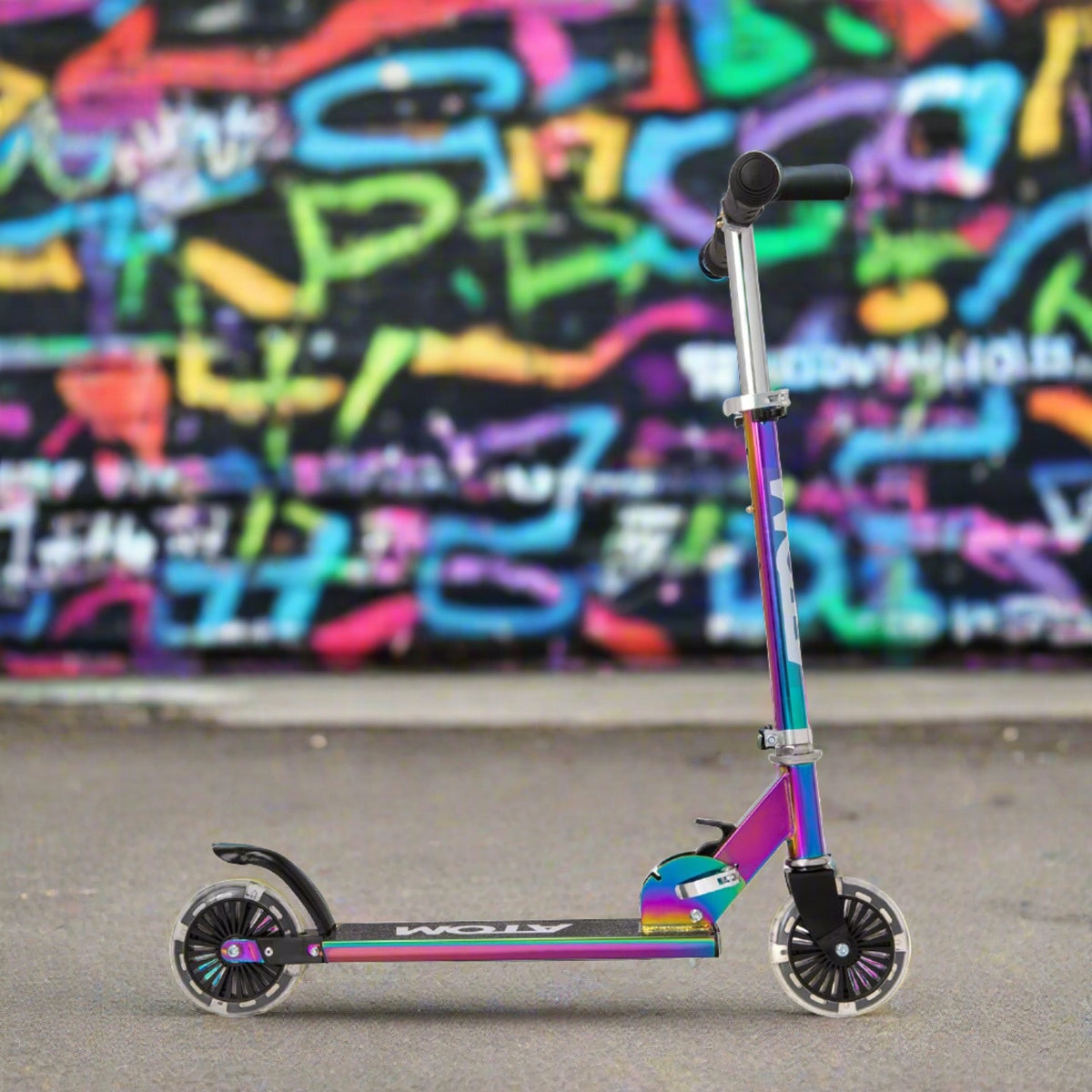 ATOM Inline Children&#39;s Kick Scooter in bright colours, designed for kids with a sturdy frame, adjustable handlebars, and smooth-rolling wheels, perfect for outdoor fun and active play.