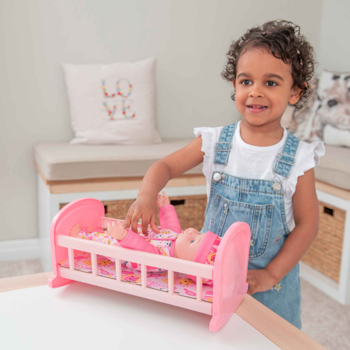 Complete with included doll, this charming cot offers a cozy resting place for dolls, fostering imaginative play and nurturing skills in children