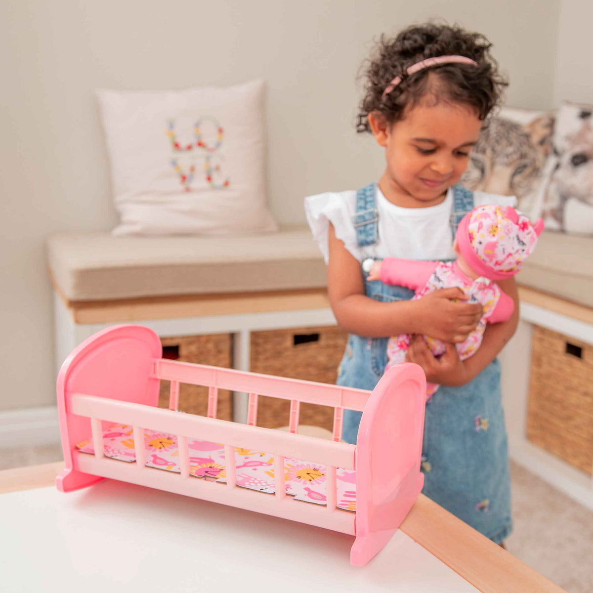 Complete with included doll, this charming cot offers a cozy resting place for dolls, fostering imaginative play and nurturing skills in children