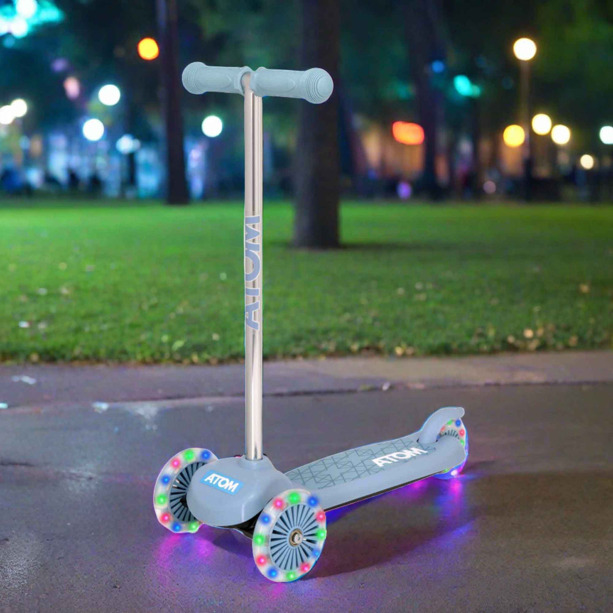 ATOM Move N Groove Light Up 3-wheeled scooter with flashing LED wheels, colourful design, and tilt to steer system, offering a fun and stable ride for children.