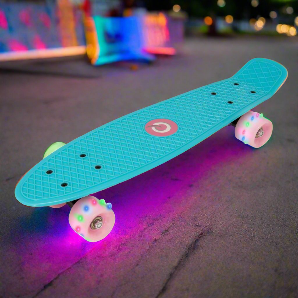 Children’s EVO 22-inch Penny Board in pink with light-up wheels, showcasing a compact design and vibrant retro style, perfect for young riders. The board features a textured grip surface and smooth, illuminated wheels that light up during movement. 