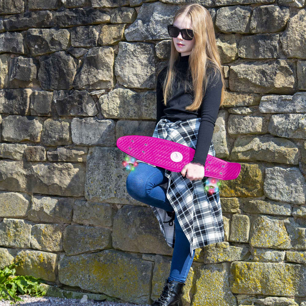 Children’s EVO 22-inch Penny Board in pink with light-up wheels, showcasing a compact design and vibrant retro style, perfect for young riders. The board features a textured grip surface and smooth, illuminated wheels that light up during movement.