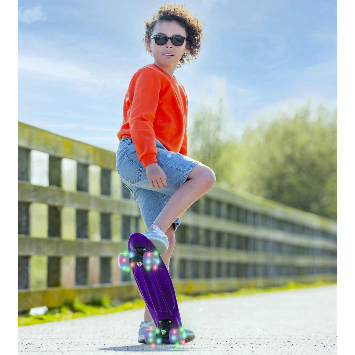 Children’s EVO 22-inch Penny Board in pink with light-up wheels, showcasing a compact design and vibrant retro style, perfect for young riders. The board features a textured grip surface and smooth, illuminated wheels that light up during movement. 