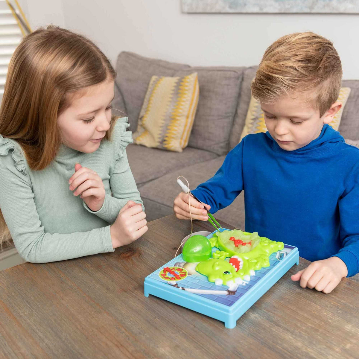 Slime Surgeon Dino Edition Board Game, a dinosaur-themed twist on the classic Shaking Surgeon game. Ideal for kids and adults, it challenges hand-eye coordination and patience with hours of dino-inspired fun.